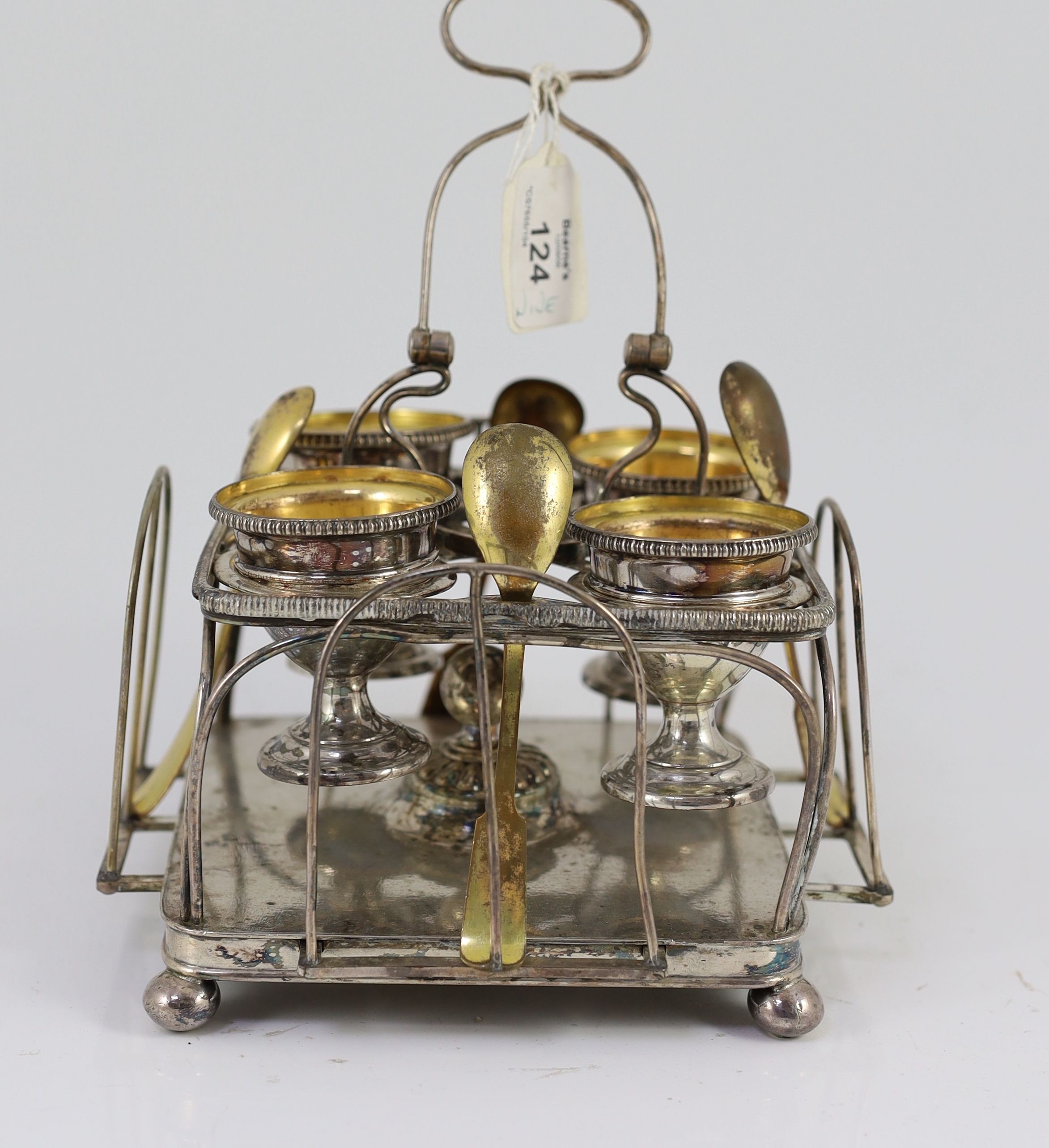A Sheffield plate egg cruet with four egg cups and spoons, 15cm wide 22cm high